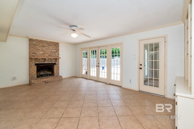 3755 N Claridge Rd, Mobile, AL 36608 - unfurnished living room with ceiling fan, french doors, crown molding, light tile patterned floors, and a fireplace