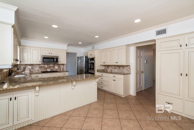 3755 N Claridge Rd, Mobile, AL 36608 - kitchen featuring stainless steel appliances, a sink, crown molding, decorative backsplash, and cream cabinets