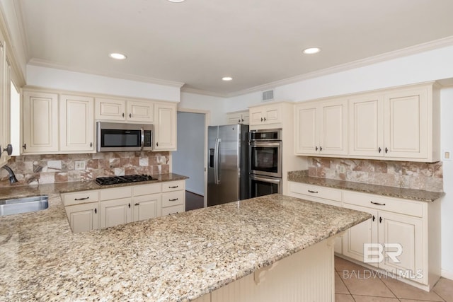 3755 N Claridge Rd, Mobile, AL 36608 - kitchen with stainless steel appliances, light stone countertops, a sink, backsplash, and recessed lighting