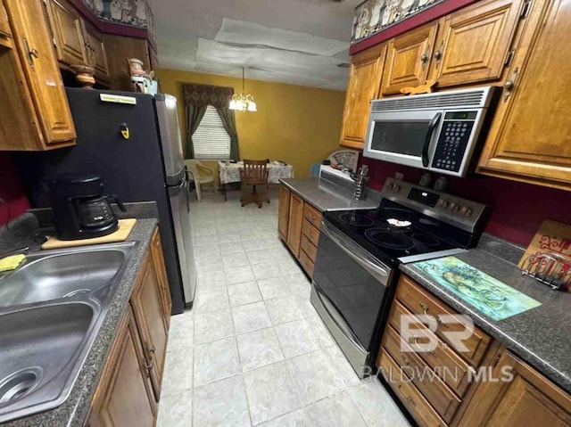 kitchen featuring dark countertops, brown cabinets, and stainless steel appliances