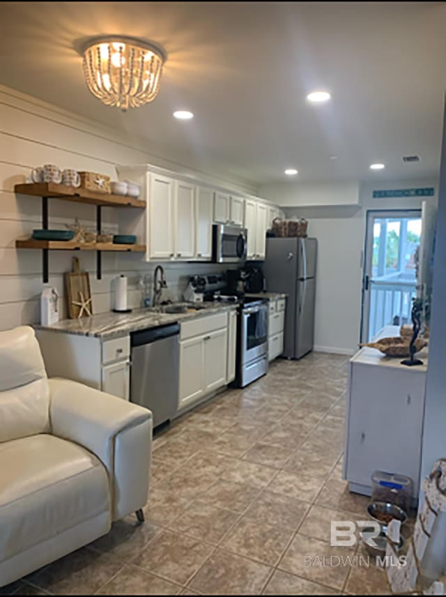 16310 Perdido Key Dr, Pensacola, FL 32507 - kitchen with stainless steel appliances, a sink, white cabinetry, open shelves, and recessed lighting