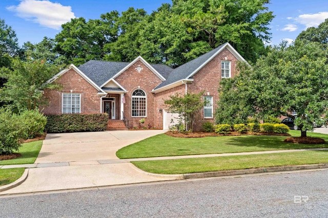 9791 Aspen Cir, Spanish Fort, AL 36527 - view of front of house featuring brick siding, concrete driveway, a front yard, and an attached garage