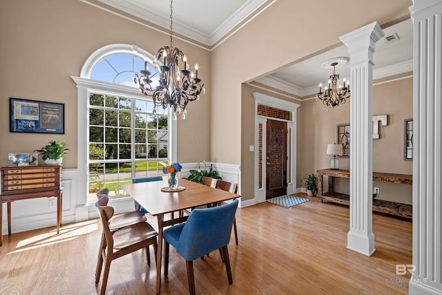9791 Aspen Cir, Spanish Fort, AL 36527 - dining area with a chandelier, light wood-style floors, crown molding, decorative columns, and wainscoting