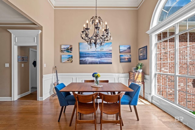 9791 Aspen Cir, Spanish Fort, AL 36527 - dining area featuring wood finished floors, plenty of natural light, crown molding, a chandelier, and wainscoting