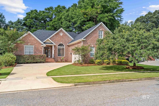 9791 Aspen Cir, Spanish Fort, AL 36527 - traditional-style home featuring brick siding, a front yard, and concrete driveway