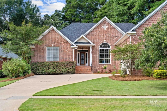9791 Aspen Cir, Spanish Fort, AL 36527 - view of front facade featuring brick siding, a front lawn, and roof with shingles
