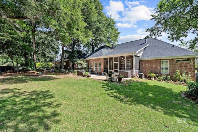 9791 Aspen Cir, Spanish Fort, AL 36527 - back of house featuring brick siding, a patio area, a sunroom, and roof with shingles