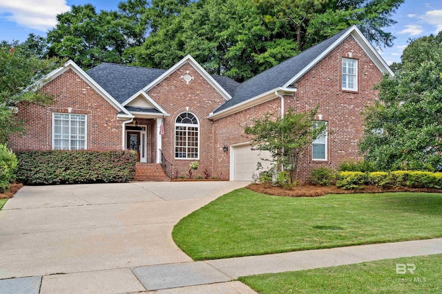 9791 Aspen Cir, Spanish Fort, AL 36527 - traditional home featuring brick siding, an attached garage, concrete driveway, a front yard, and a shingled roof