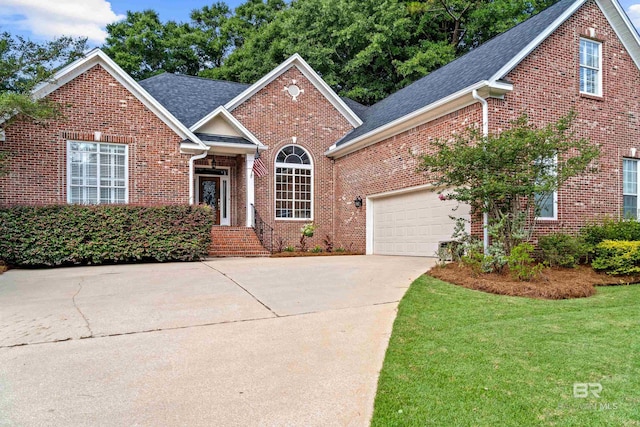 9791 Aspen Cir, Spanish Fort, AL 36527 - traditional home featuring brick siding, a shingled roof, concrete driveway, an attached garage, and a front yard
