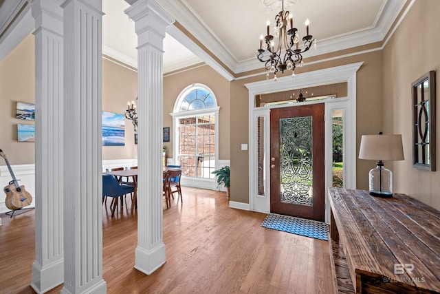 9791 Aspen Cir, Spanish Fort, AL 36527 - entryway with ornate columns, a chandelier, wood finished floors, and crown molding