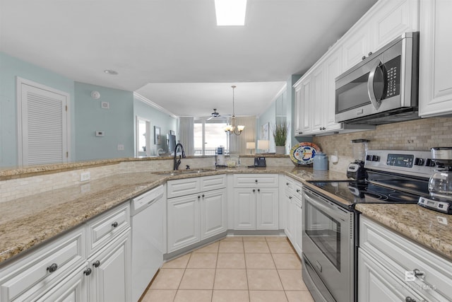 kitchen with sink, light tile patterned floors, stainless steel appliances, and white cabinets