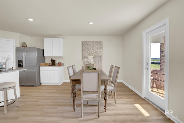 dining space with light wood-type flooring