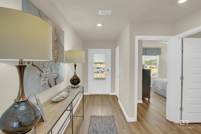 hall with light hardwood / wood-style floors