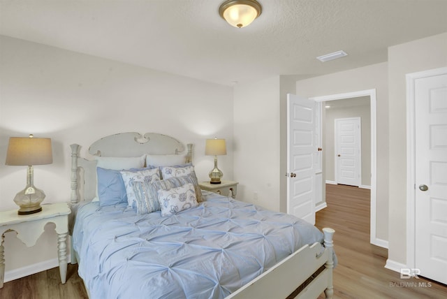 bedroom with wood-type flooring