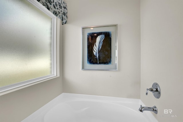 bathroom with a healthy amount of sunlight and a bath