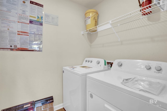 clothes washing area with washing machine and dryer