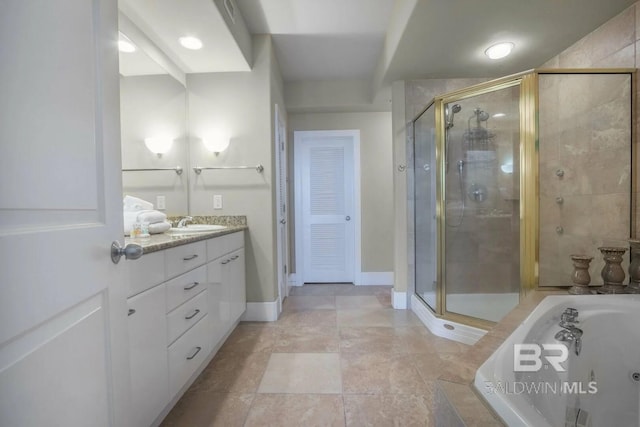 28107 Perdido Beach Blvd Unit D209, Orange Beach, AL 36561 - full bathroom featuring a garden tub, a stall shower, vanity, and baseboards