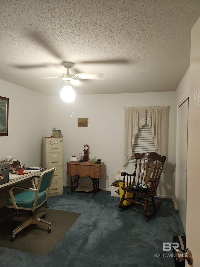 carpeted home office featuring ceiling fan and a textured ceiling