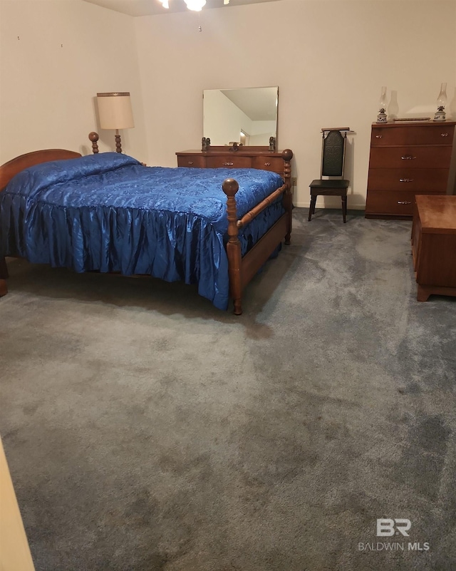 bedroom featuring dark colored carpet