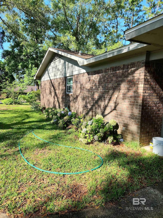 view of side of property with a lawn