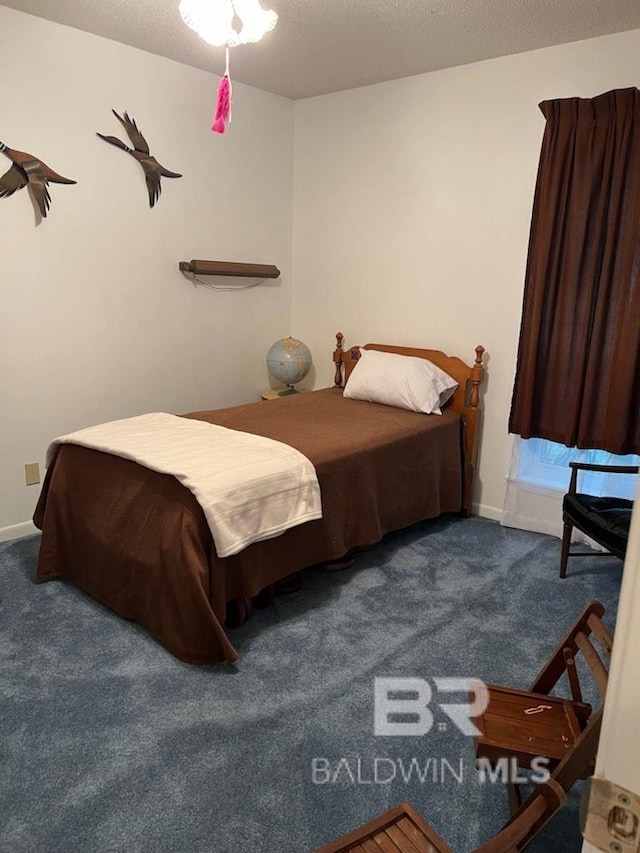 carpeted bedroom with a textured ceiling