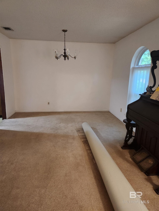 6128 N Lindholm Dr, Mobile, AL 36693 - carpeted dining room featuring a chandelier and a textured ceiling