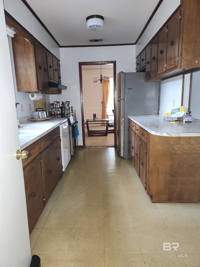 kitchen featuring dark brown cabinetry, ornamental molding, white dishwasher, and stainless steel refrigerator