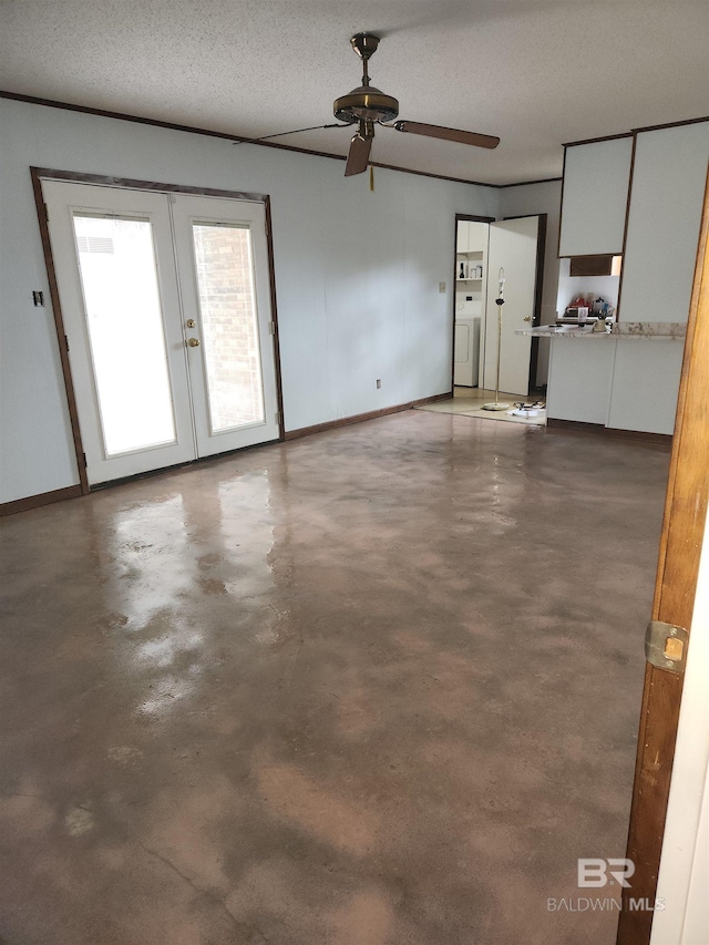 interior space featuring french doors, ceiling fan, washer / dryer, and a textured ceiling