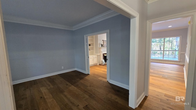 hall with wood-type flooring and crown molding