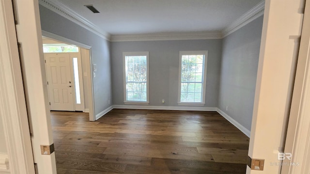 foyer featuring dark hardwood / wood-style floors, a wealth of natural light, and ornamental molding