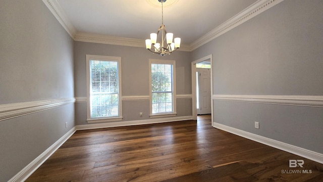 unfurnished room featuring a notable chandelier, dark hardwood / wood-style flooring, and ornamental molding