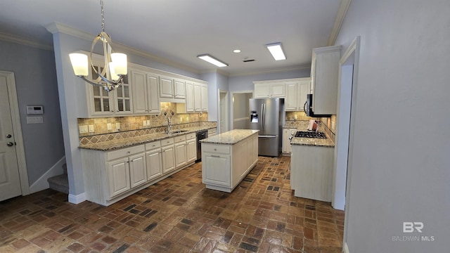 kitchen with a center island, backsplash, sink, stainless steel refrigerator with ice dispenser, and decorative light fixtures