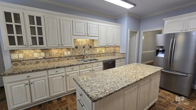 kitchen featuring white cabinets, stainless steel appliances, a kitchen island, and sink