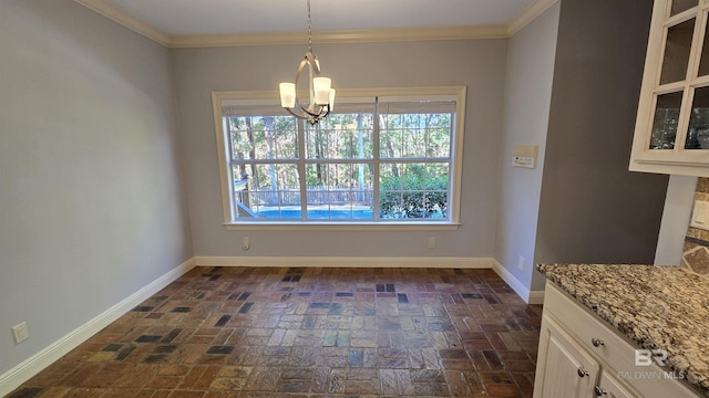 unfurnished dining area featuring a notable chandelier and crown molding