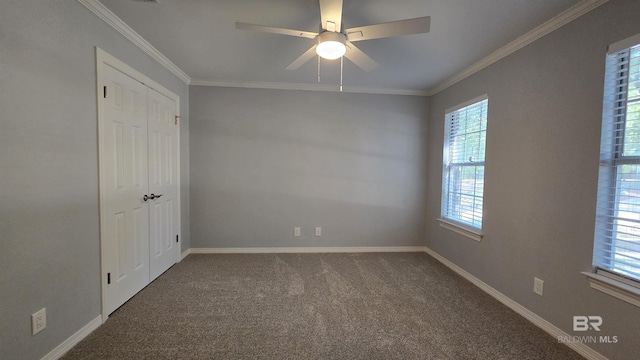 carpeted spare room with ceiling fan and crown molding