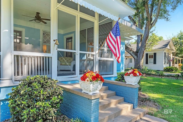 exterior space with a lawn, ceiling fan, and covered porch