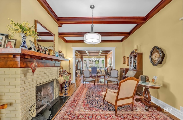 interior space with a brick fireplace, beam ceiling, hardwood / wood-style flooring, and crown molding