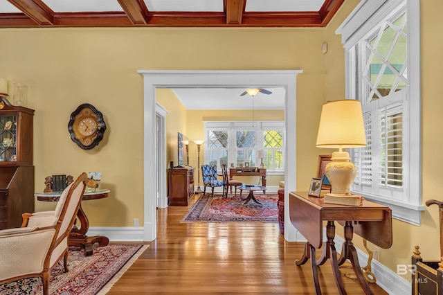 interior space featuring coffered ceiling, beam ceiling, hardwood / wood-style floors, and ceiling fan