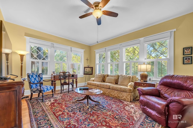 living room featuring a healthy amount of sunlight, light hardwood / wood-style floors, and ceiling fan