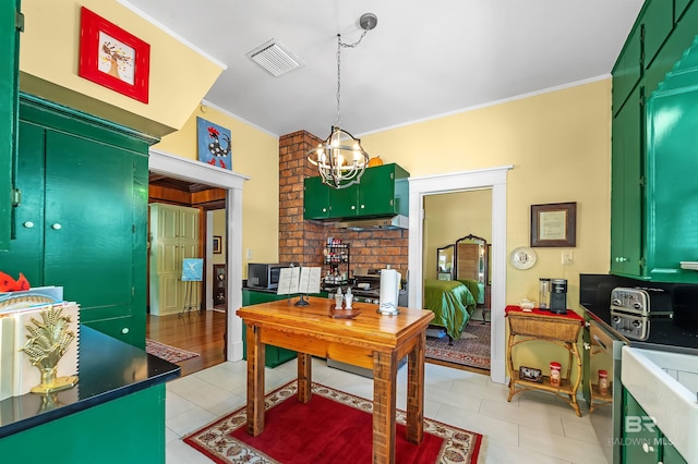 kitchen with an inviting chandelier, green cabinetry, and decorative light fixtures