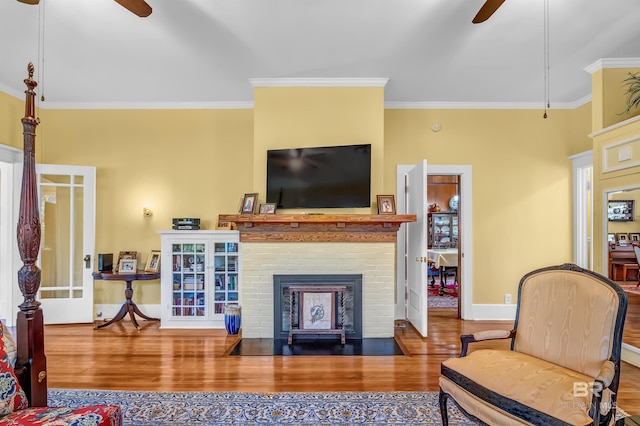 living room with ornamental molding, ceiling fan, and hardwood / wood-style flooring