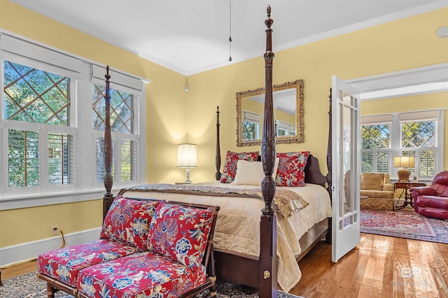 bedroom with wood-type flooring and crown molding