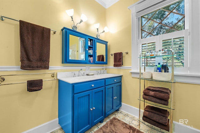 bathroom with a wealth of natural light, vanity, and crown molding