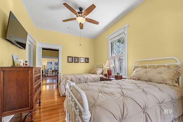 bedroom with light hardwood / wood-style floors and ceiling fan