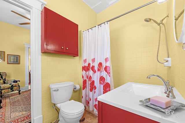 bathroom featuring tile walls, a shower with curtain, vanity, and toilet