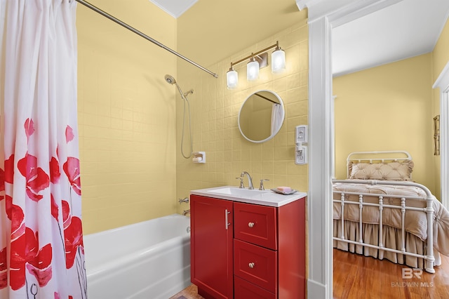 bathroom with tile walls, tasteful backsplash, vanity, wood-type flooring, and shower / tub combo with curtain