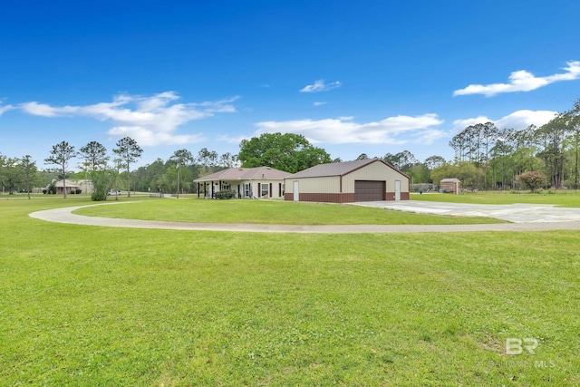 view of community with concrete driveway and a lawn