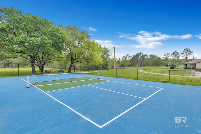view of tennis court featuring fence and community basketball court