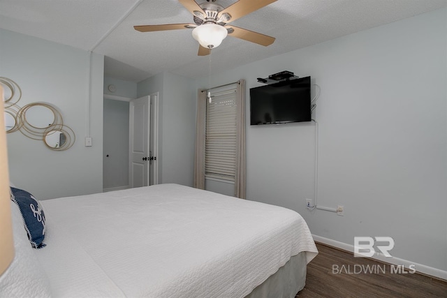 bedroom with dark wood finished floors, ceiling fan, and baseboards