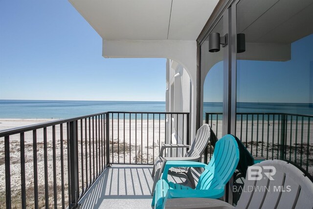 balcony with a view of the beach and a water view